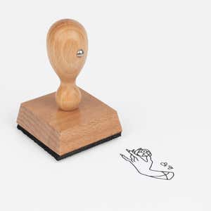 Eerie Hand Eye Craft Stamp at an angle with its wooden handle and block