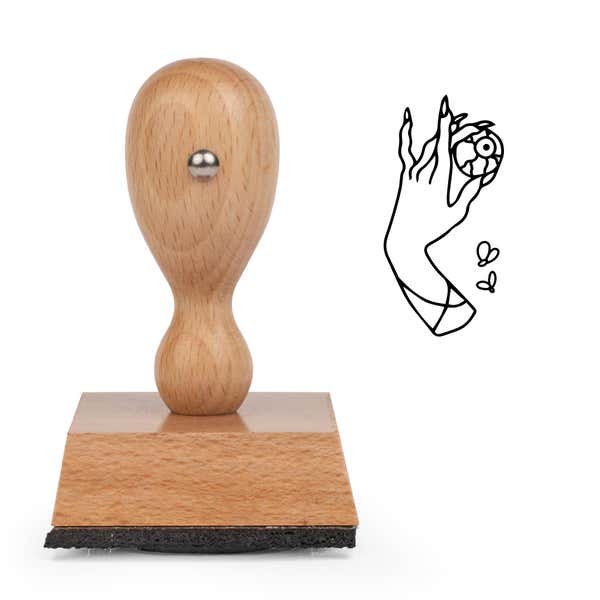 Eerie Hand Eye Craft Stamp standing upright beside its black stamped hand and eyeball image
