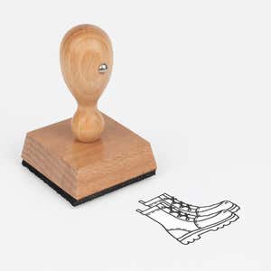 Hiking Boots Craft Stamp at an angle with its wooden handle and block