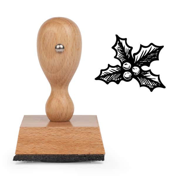 Evergreen Holly Craft Stamp standing upright beside its black stamped evergreen holly image