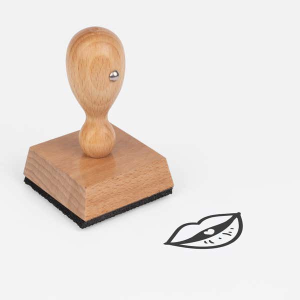Puckered Kissing Lips Craft Stamp at an angle with its wooden handle and block