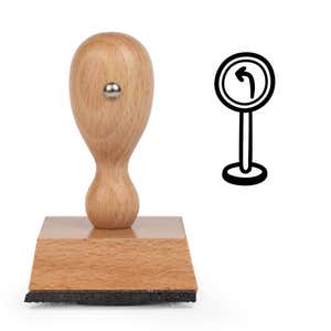 Left Turn Sign Craft Stamp standing upright beside its black stamped left turn sign image