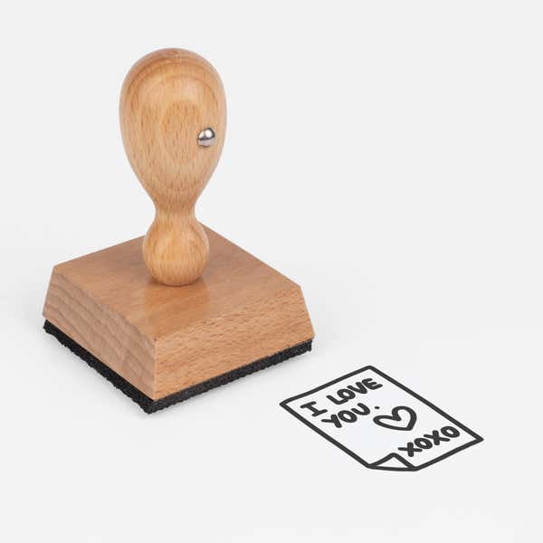 Secret Love Note Craft Stamp at an angle with its wooden handle and block