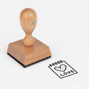 Sweet Love Notepad Craft Stamp at an angle with its wooden handle and block