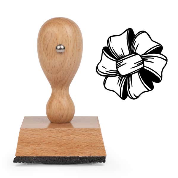 Tied Ribbon Bow Craft Stamp standing upright beside its black stamped tied ribbon bow image