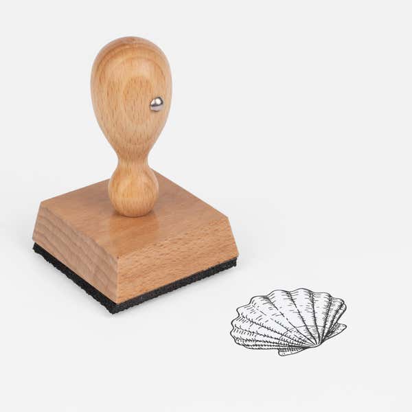 Scallop Shell Craft Stamp at an angle with its wooden handle and block