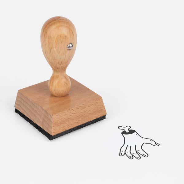 Gruesome Severed Hand Craft Stamp at an angle with its wooden handle and block