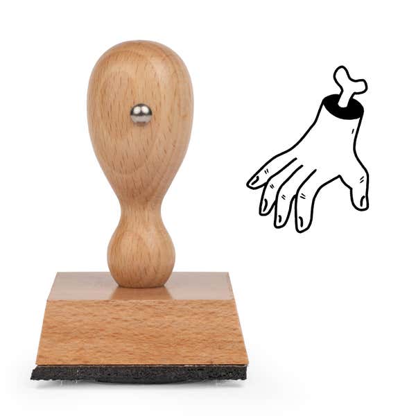 Gruesome Severed Hand Craft Stamp standing upright beside its black stamped severed hand image