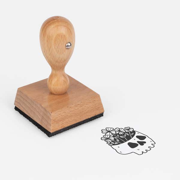 Gothic Skull Plant Craft Stamp at an angle with its wooden handle and block