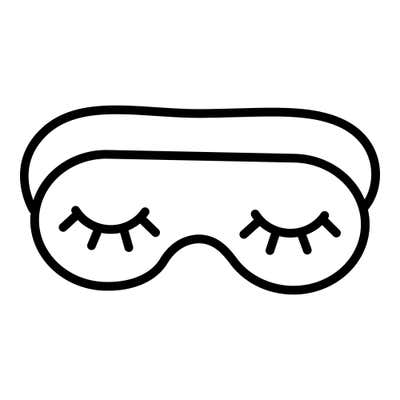 Sleep mask with two closed eyes and curved lashes, its strap showing behind