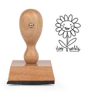 Happy Smiling Daisy Craft Stamp standing upright beside its black stamped daisy image