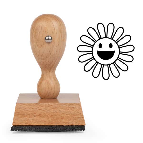 Beaming Sunburst Flower Craft Stamp standing upright beside its black stamped beaming sunburst flower image