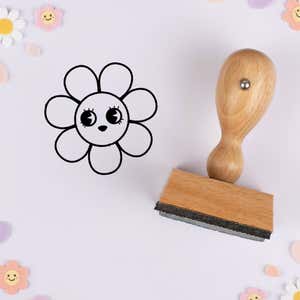 Sparkle-eyed flower stamped in black on lavender cardstock with smiling daisy confetti