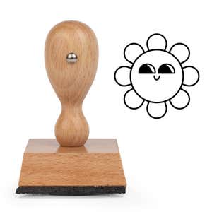 Sly Glance Flower Craft Stamp standing upright beside its black stamped sly glance flower image