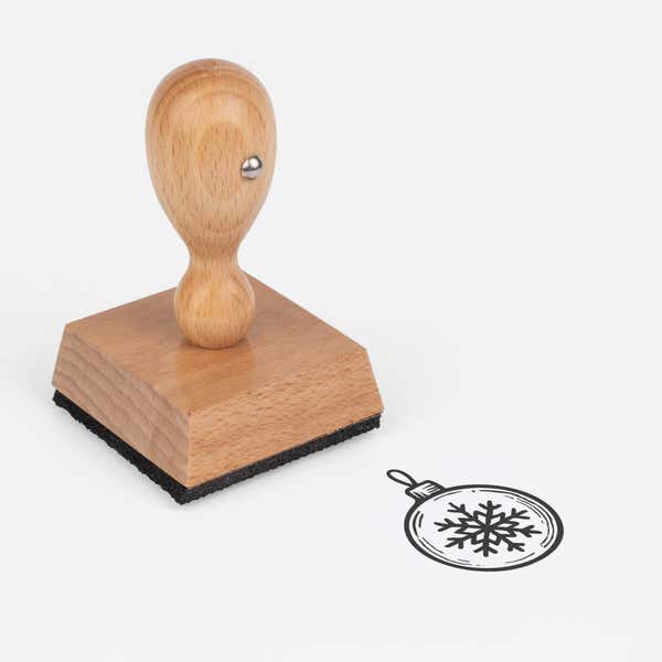 Winter Snowflake Ornament Craft Stamp at an angle with its wooden handle and block