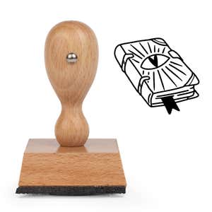 Witchy Spell Book Craft Stamp standing upright beside its black stamped spell book image