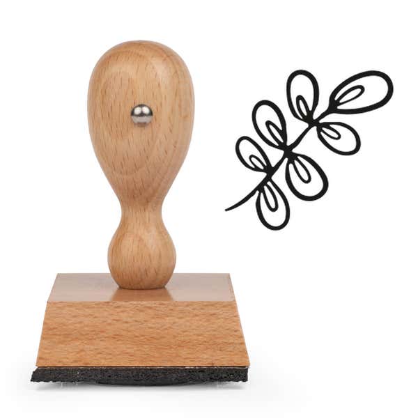 Dainty Spring Sprig Craft Stamp standing upright beside its black stamped spring sprig image