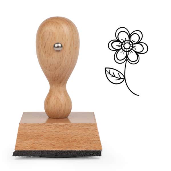 Blooming Spring Flower Craft Stamp standing upright beside its black stamped flower image