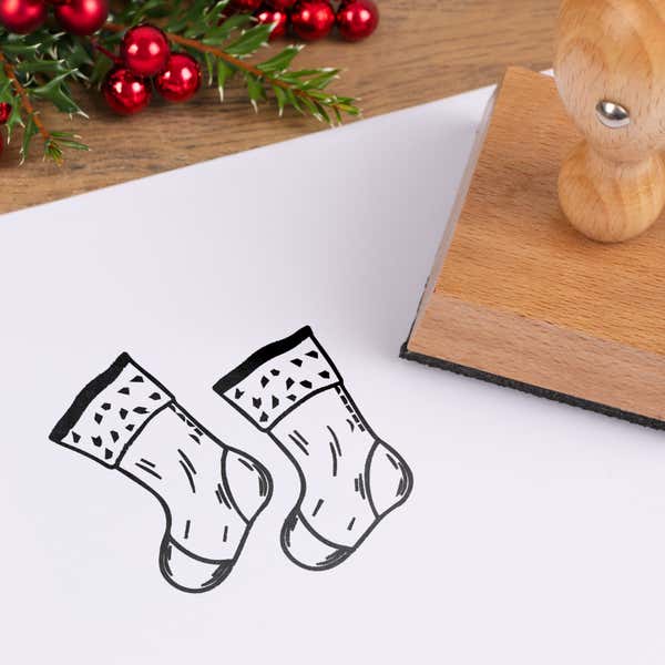 Mantel Christmas stockings stamped in black on white cardstock styled with red berries and pine greenery