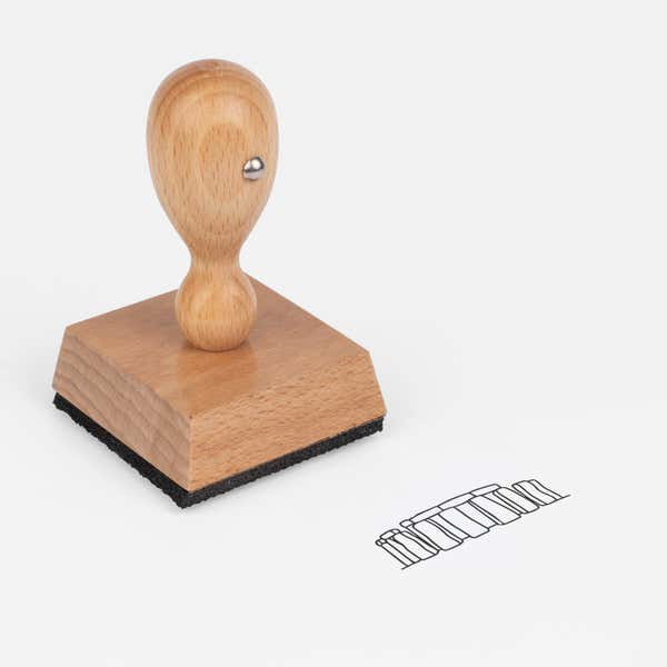 Stonehenge Craft Stamp at an angle with its wooden handle and block
