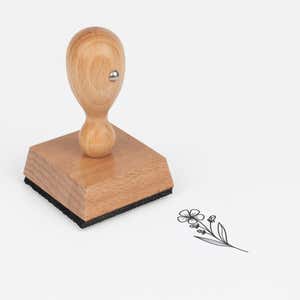 Five-Petal Wildflower Stem Craft Stamp at an angle with its wooden handle and block