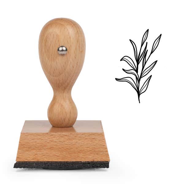 Slender Leaf Sprig Craft Stamp standing upright beside its black stamped slender leaf sprig image