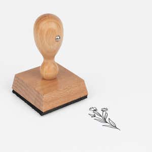 Dainty Bud Stems Craft Stamp at an angle with its wooden handle and block