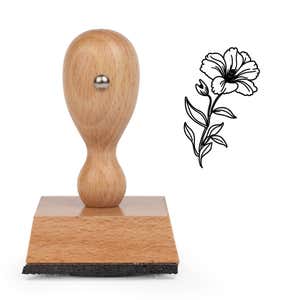 Ruffled Bloom and Bud Craft Stamp standing upright beside its black stamped ruffled bloom and bud image