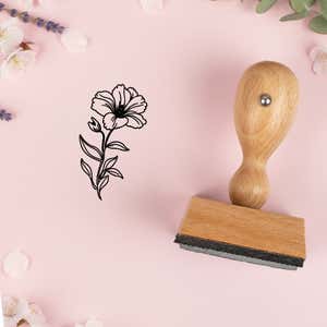 Ruffled bloom and bud stamped in black on pink cardstock with lavender sprigs and blossoms