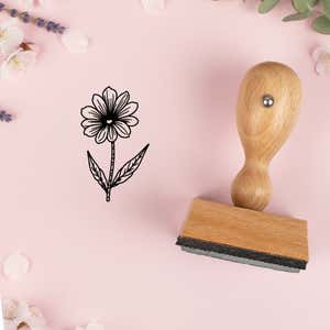 Fine-line daisy stem stamped in black on pink cardstock with lavender sprigs and blossoms