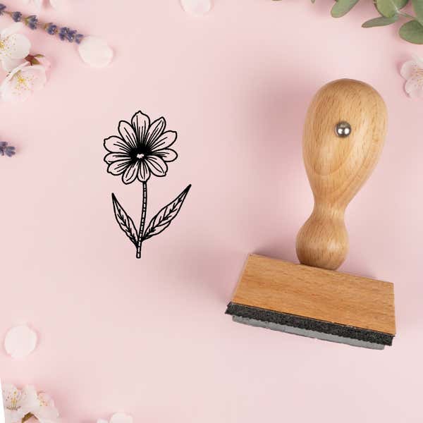Fine-line daisy stem stamped in black on pink cardstock with lavender sprigs and blossoms