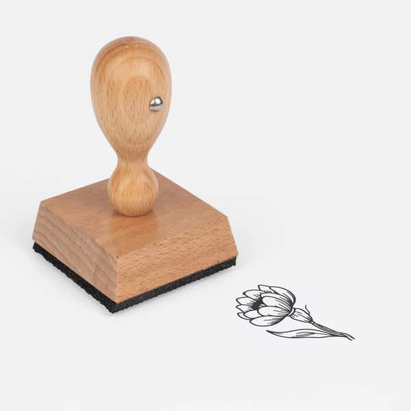 Layered Petal Bloom Craft Stamp at an angle with its wooden handle and block