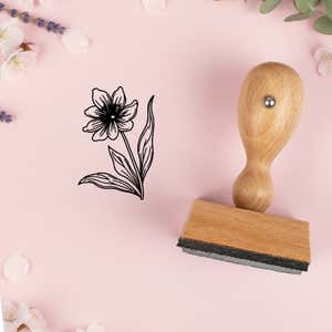 Six-petal meadow flower stamped in black on pink cardstock with lavender sprigs and blossoms