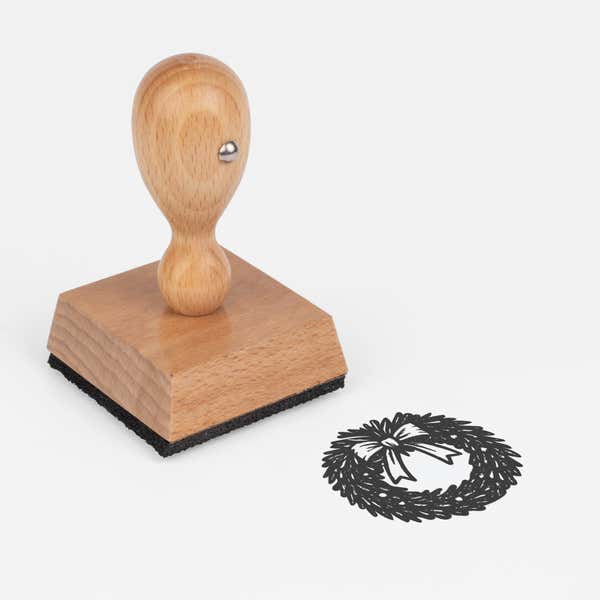Seasonal Christmas Wreath Craft Stamp at an angle with its wooden handle and block