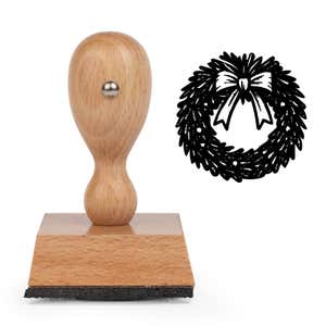 Seasonal Christmas Wreath Craft Stamp standing upright beside its black stamped seasonal Christmas wreath image