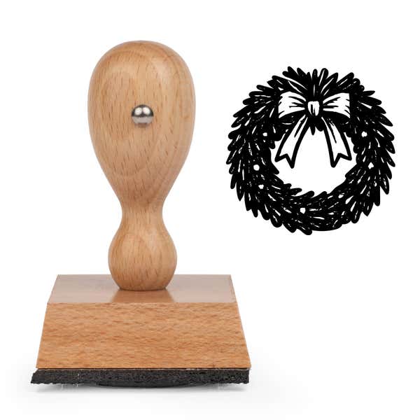 Seasonal Christmas Wreath Craft Stamp standing upright beside its black stamped seasonal Christmas wreath image