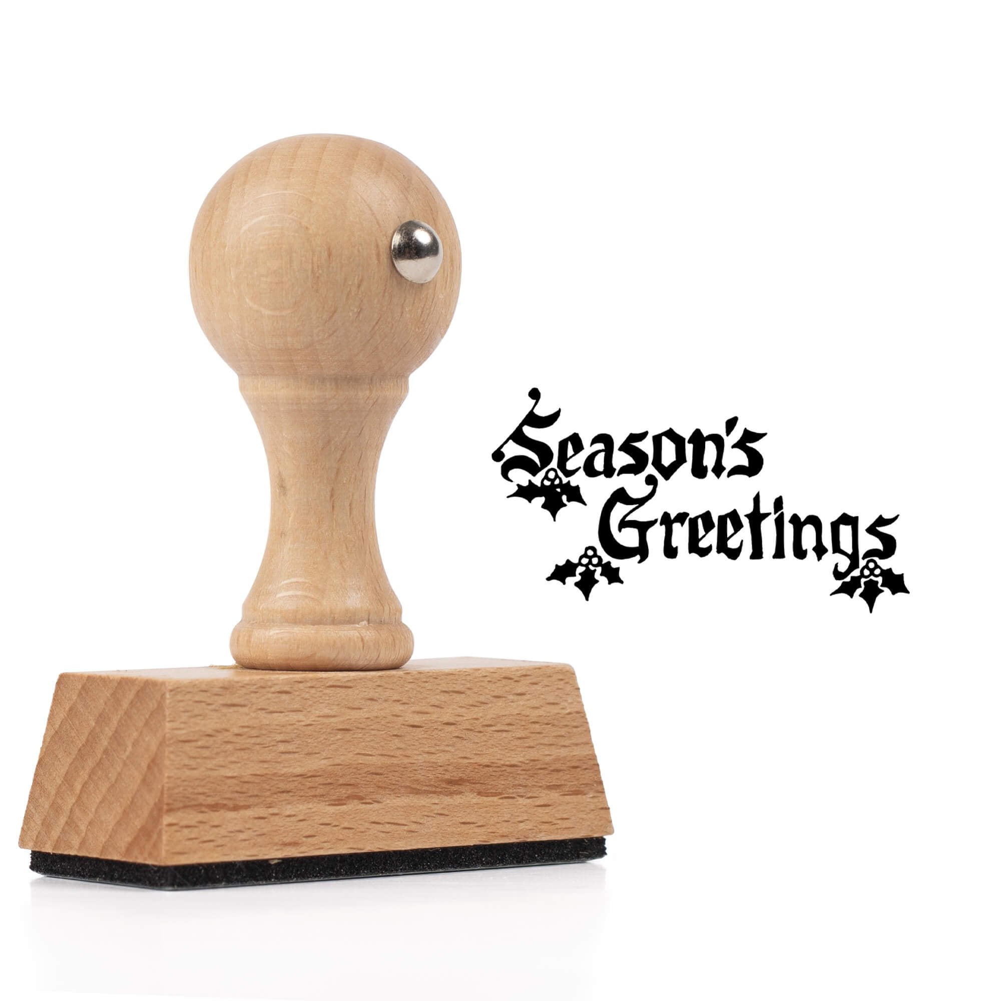 Season’s Greetings European hand stamp shown beside wooden stamp body on a clean white background.