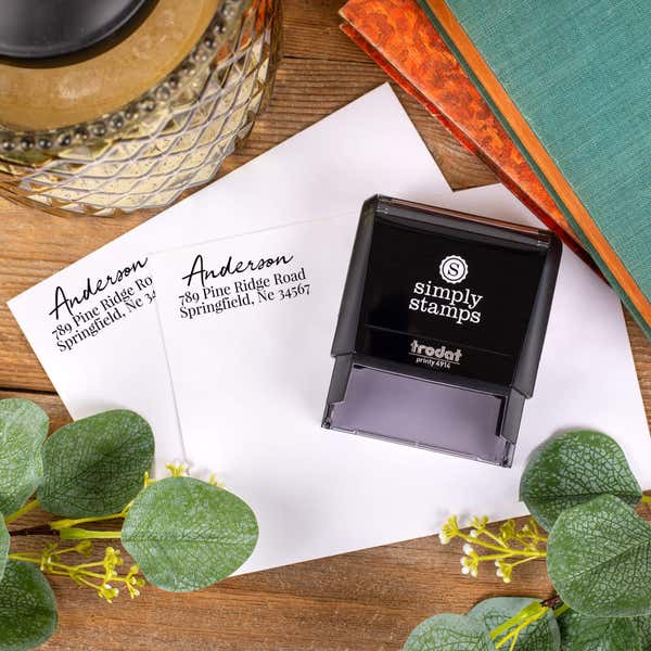 Relaxed Script Custom Address Stamp impression on front of two envelopes top down view