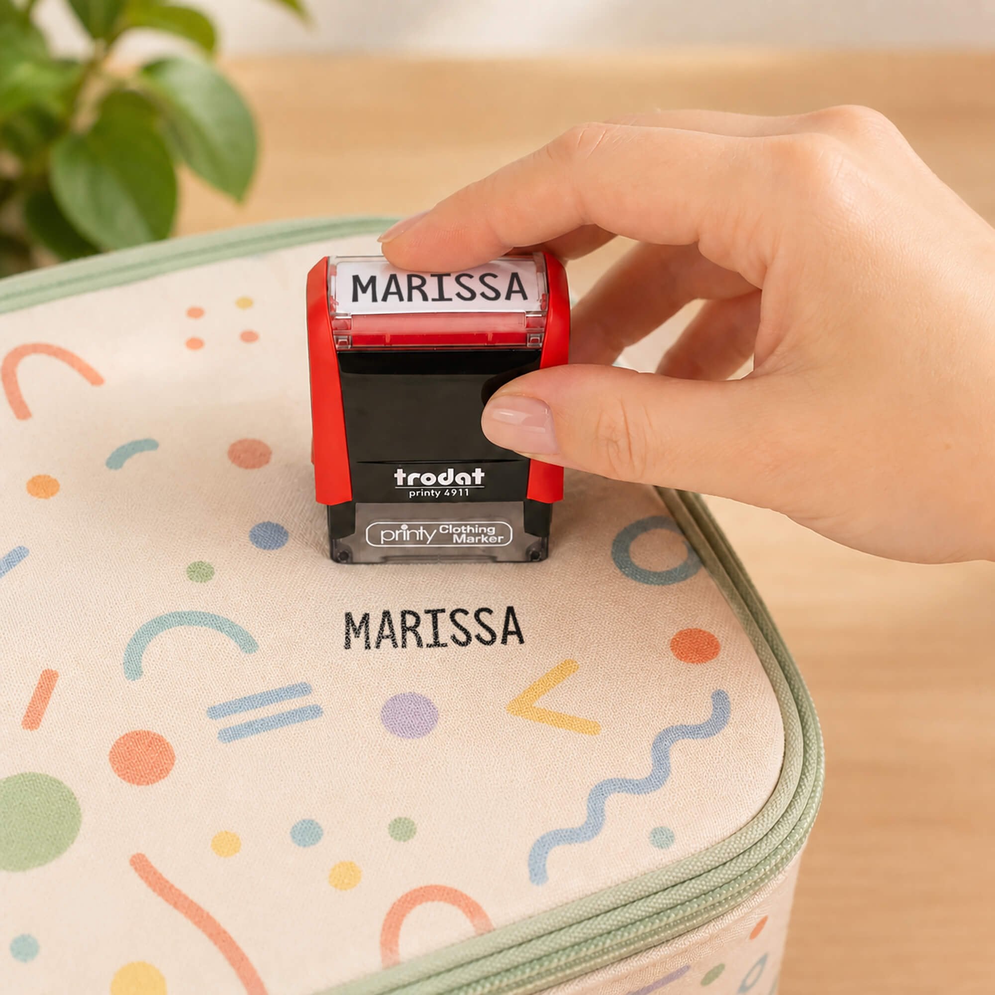 Fun Clothing Stamp being pressed onto a lunchbox