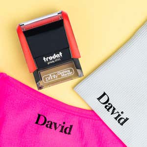 Example of the Trodat 4911 Clothing Name Stamp in Serif font on different colors