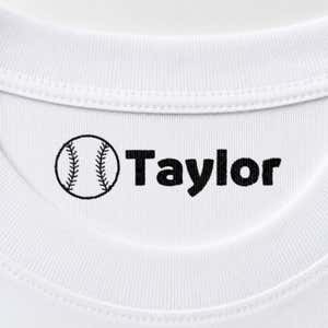 Baseball name stamp reading Taylor inside the collar of a white shirt