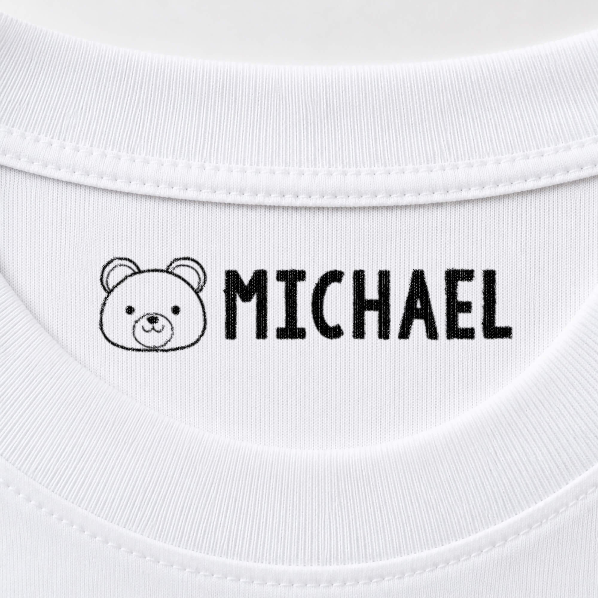 Bear name stamp reading Michael inside the collar of a white shirt