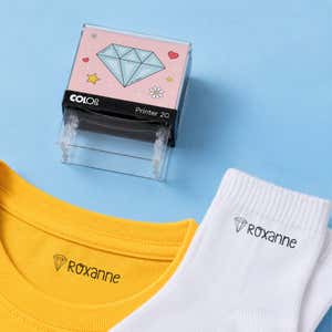 Diamond clothing name stamp with a yellow shirt and white socks labeled Roxanne