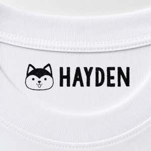 Dog name stamp reading Hayden inside the collar of a white shirt