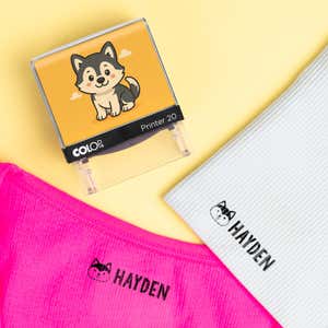 Dog clothing name stamp beside pink and light blue shirts labeled Hayden