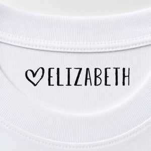 Heart name stamp reading Elizabeth inside the collar of a white shirt