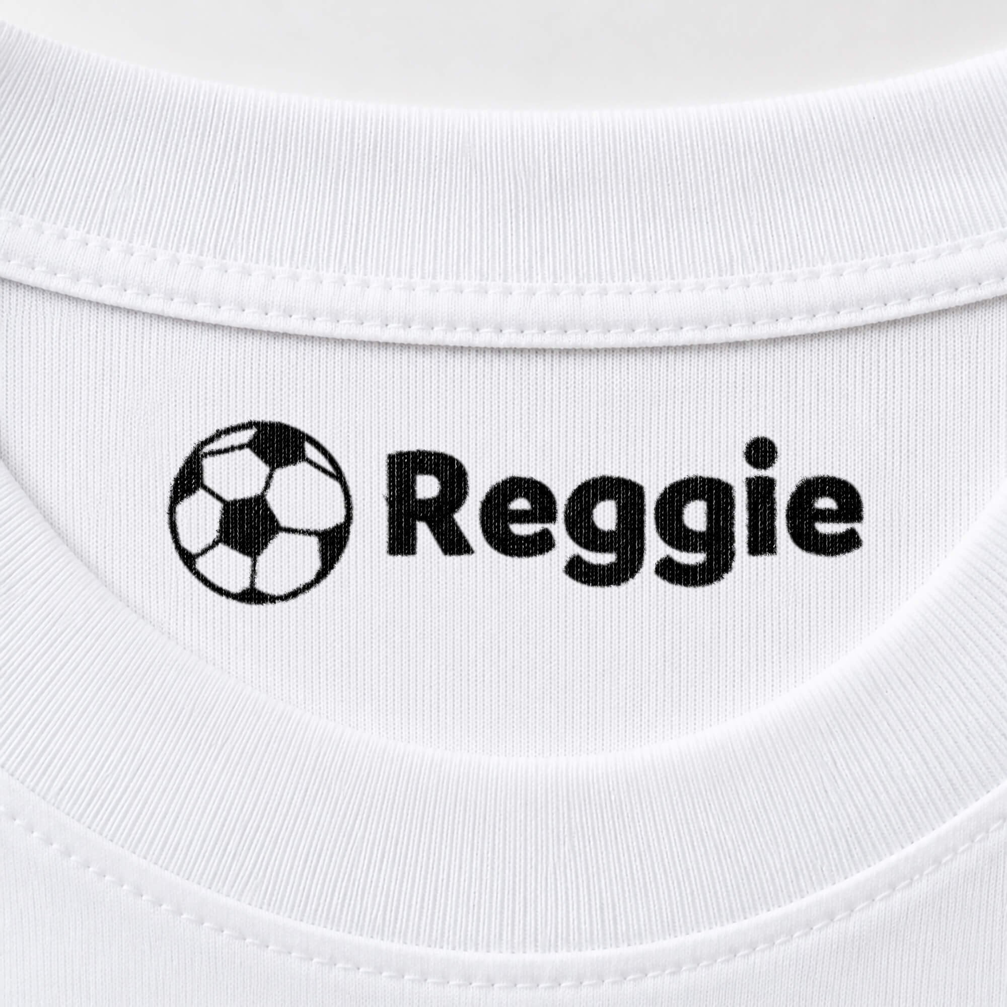 Soccer name stamp reading Reggie inside the collar of a white shirt