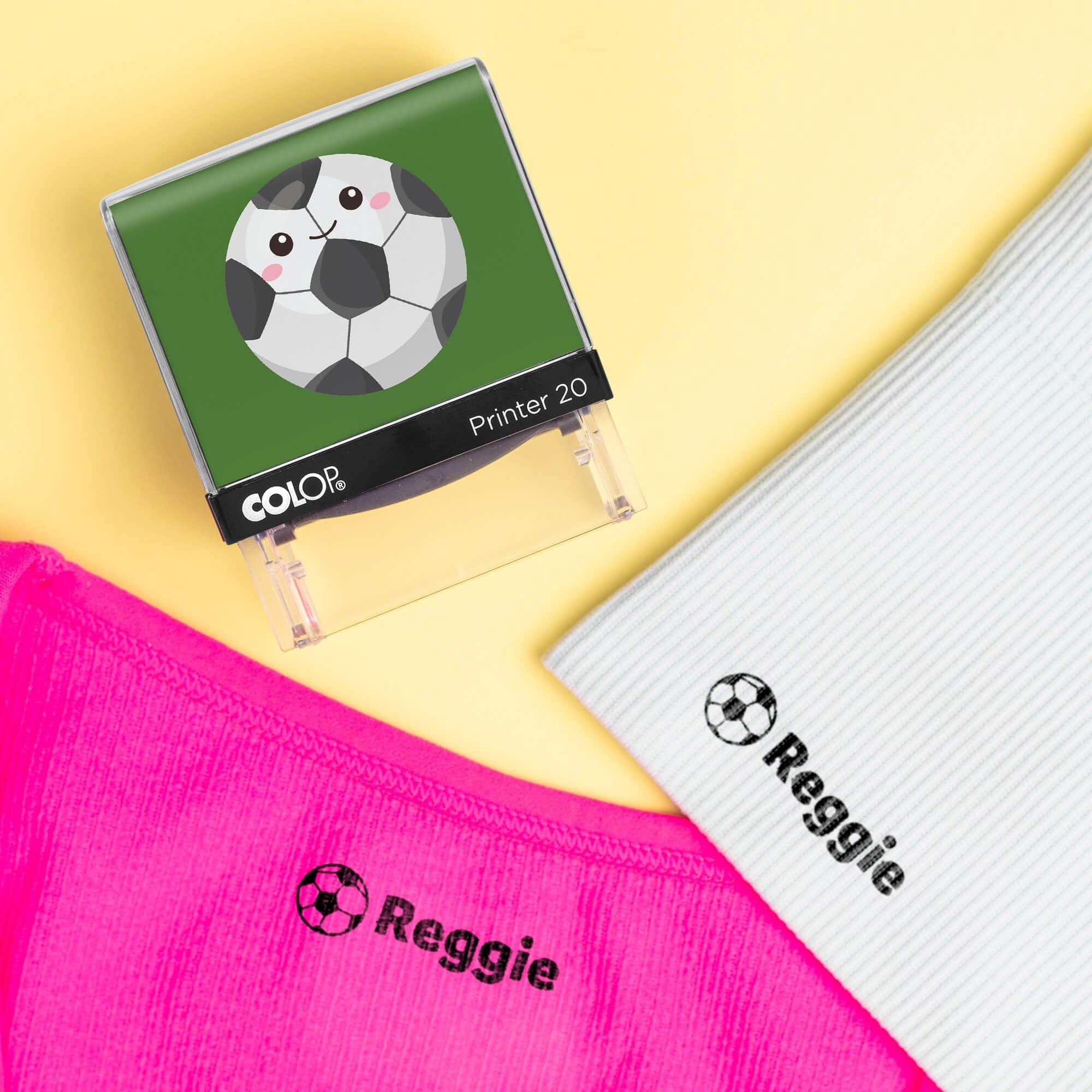 Soccer clothing name stamp beside pink and light gray shirts labeled Reggie