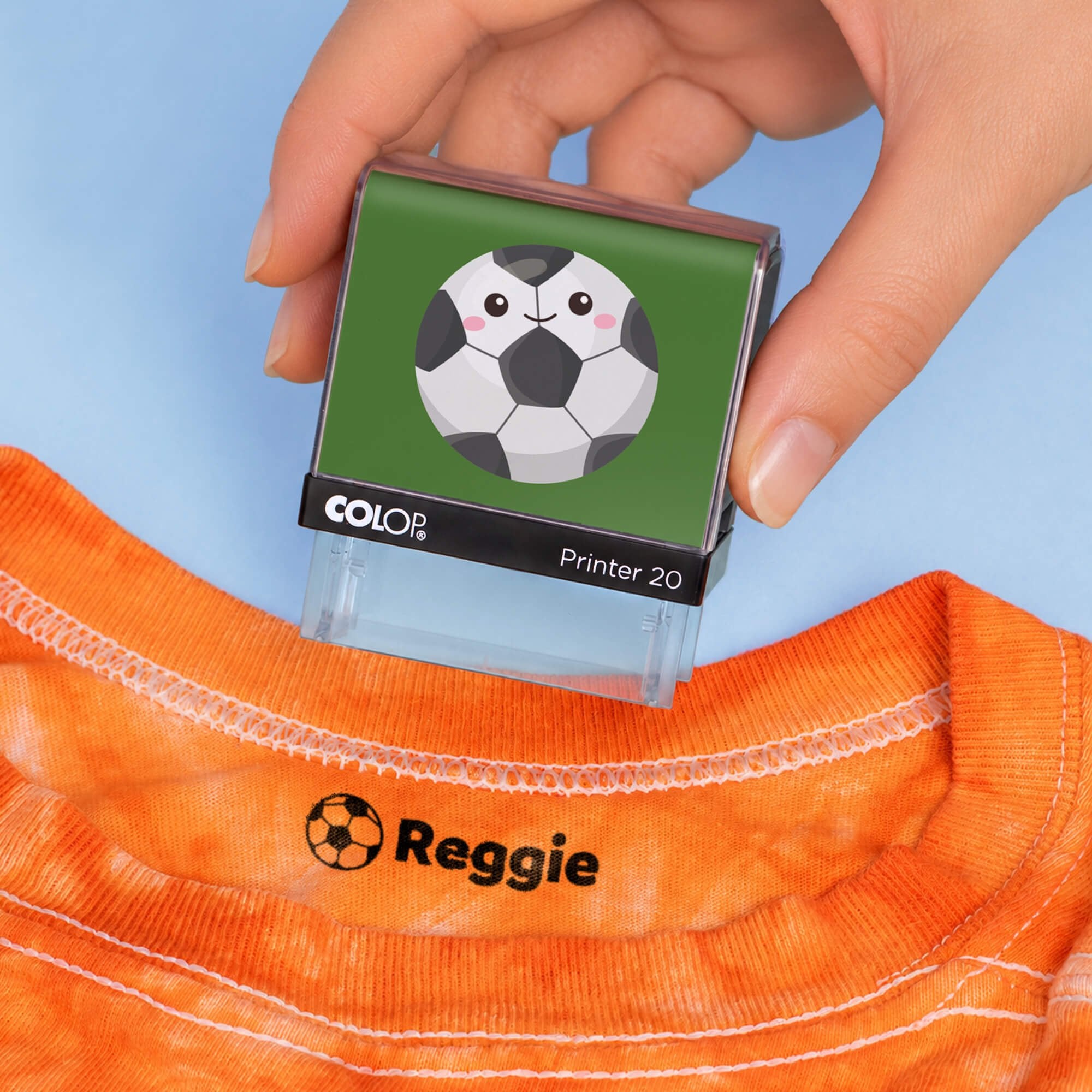 Soccer clothing name stamp above an orange shirt collar labeled Reggie
