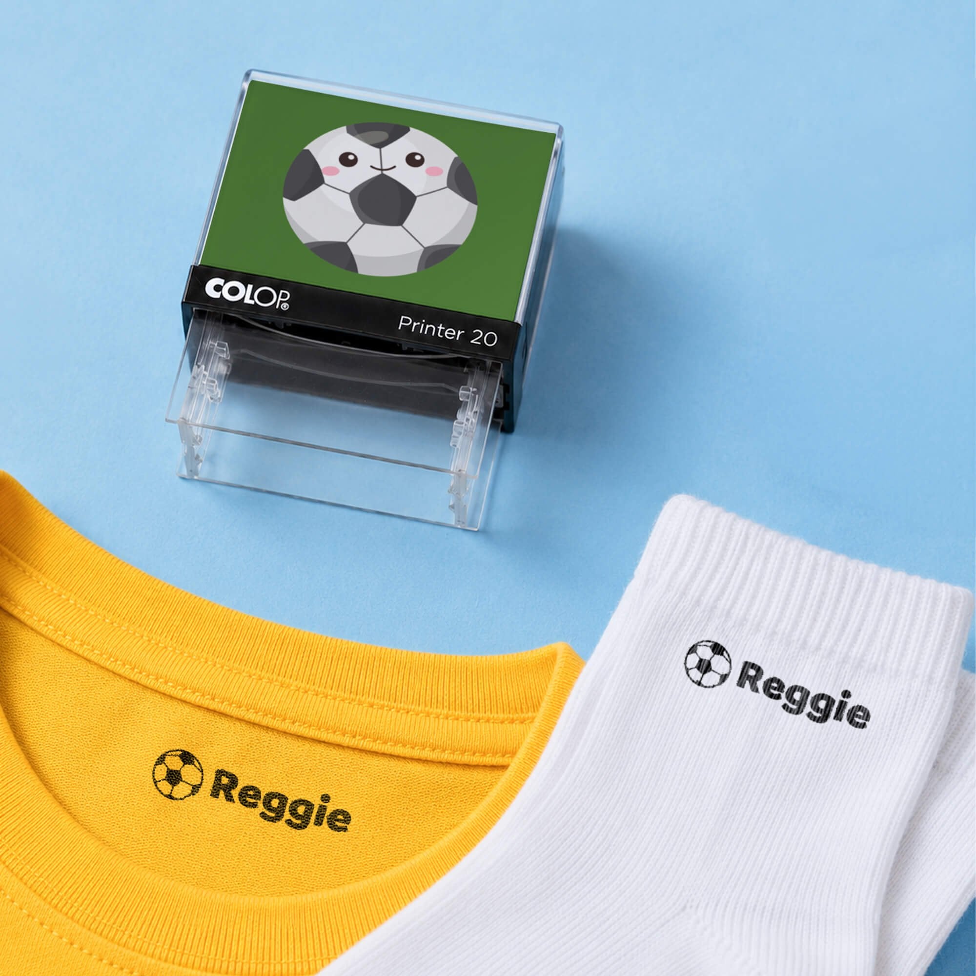Soccer clothing name stamp with a yellow shirt and white socks labeled Reggie